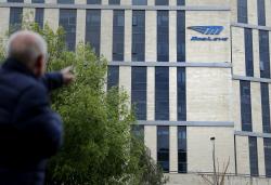 A man walks past the logo of Israeli car tech firm Mobileye on the company's offices in Jerusalem on March 13, 2017.
Intel will buy Mobileye for more than $15 billion (14 billion euros), the companies said, in a deal signalling the US computer chip giant's commitment to technology for self-driving vehicles. / AFP PHOTO / THOMAS COEX        (Photo credit should read THOMAS COEX/AFP via Getty Images)