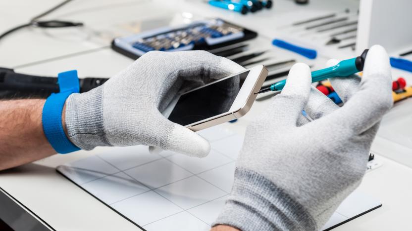 Technician replacing the screen of a used smartphone