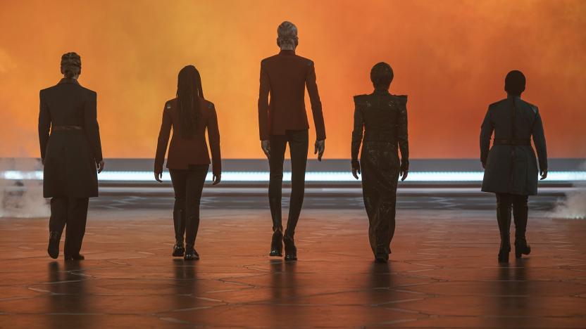 Five Star Trek: Discovery characters walk away into an orange void with their backs to the camera.