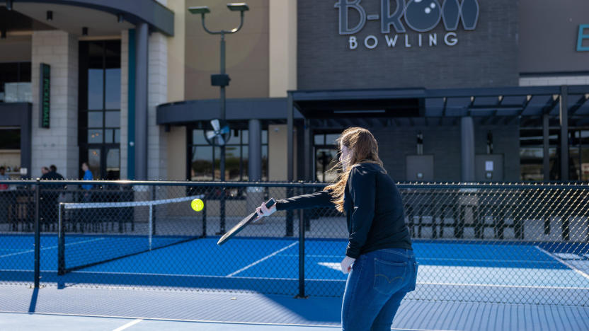 A person on a court holding a racket .