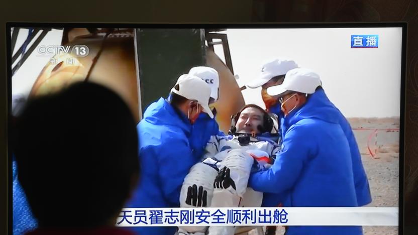 FUYANG, CHINA - APRIL 16, 2022 - A woman watches a live TV broadcast of the successful landing of the Shenzhou XI-3 re-entry module in Fuyang, East China's Anhui province, April 16, 2022. After the successful landing of the shenzhou 13 manned spacecraft re-entry module at the Dongfeng landing ground, the astronauts Zhai Zhigang, Ye Guangfu and Wang Yaping left the module. (Photo credit should read Costfoto/Future Publishing via Getty Images)