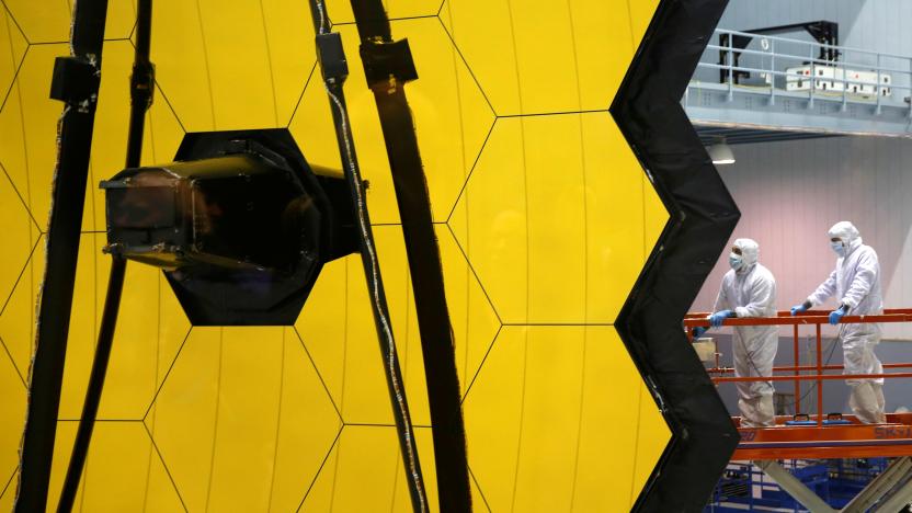 NASA workers are lifted alongside the James Webb Space Telescope Mirror during it's media reveal at NASA’s Goddard Space Flight Center at Greenbelt, Maryland, U.S., November 2, 2016.REUTERS/Kevin Lamarque