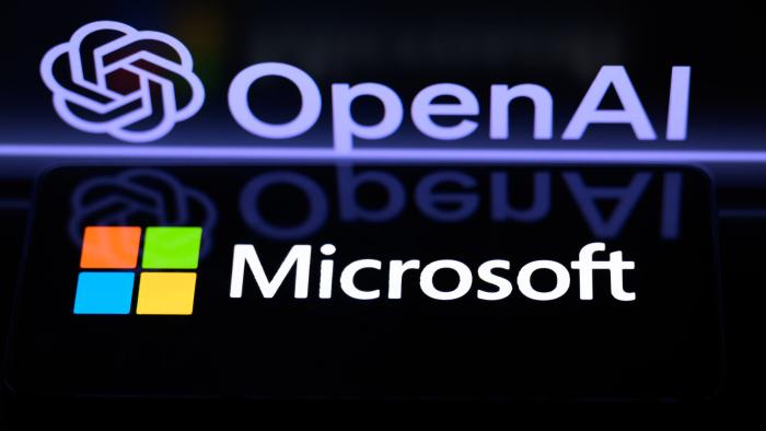 The Microsoft logo is being displayed on a smart phone, with the OpenAI logo visible on the screen in the background, in this photo illustration taken in Brussels, Belgium, on January 6, 2024. (Photo by Jonathan Raa/NurPhoto via Getty Images)