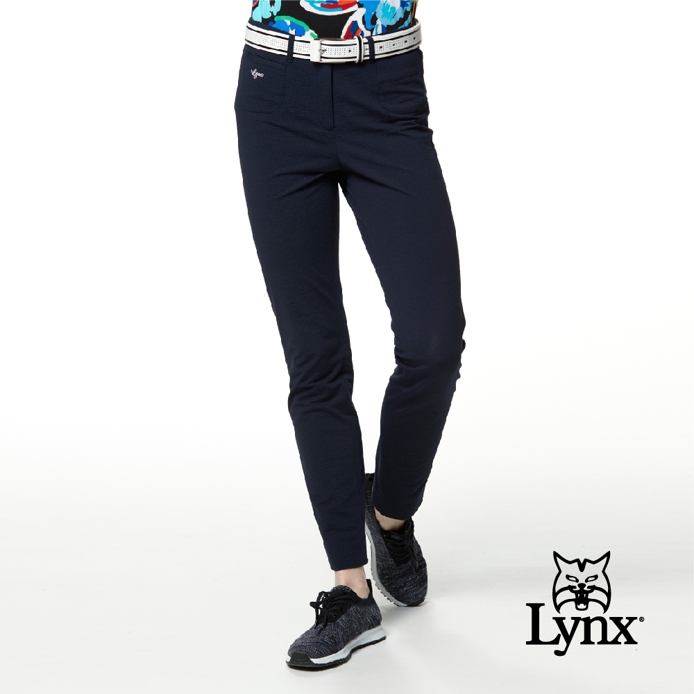 【Lynx Golf】女款日本進口布料造型袋唇設計直條紋窄管九分褲-深藍色