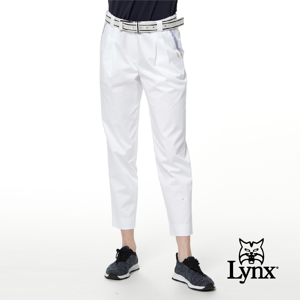 【Lynx Golf】女款彈性舒適草寫字體前袋配布設計打摺九分褲-白色